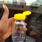 Clear 250ml PET plastic honey packaging jar from Eloquent Prints & Packaging, ideal for premium pure honey display and storage.