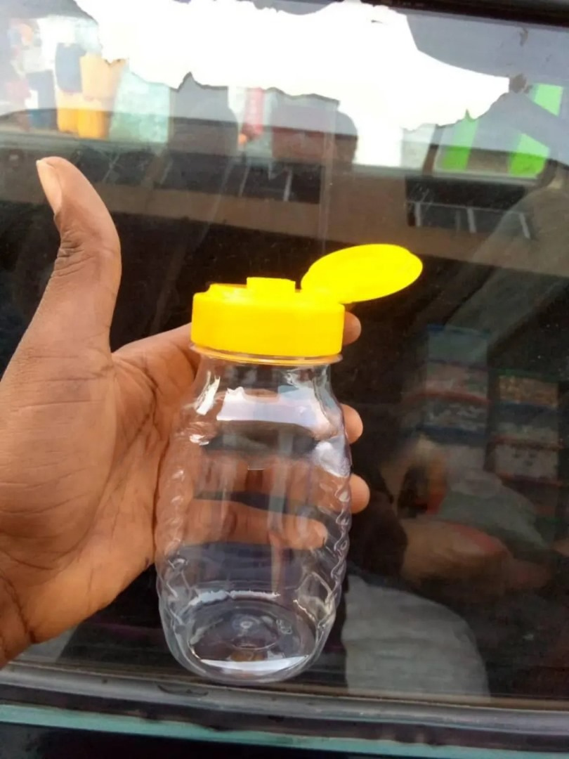 Clear 250ml PET plastic honey packaging jar from Eloquent Prints & Packaging, ideal for premium pure honey display and storage.