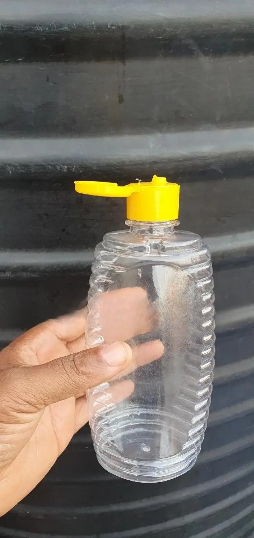 Clear 500ml PET plastic honey packaging jar from Eloquent Prints & Packaging, perfect for bulk pure honey storage and display.